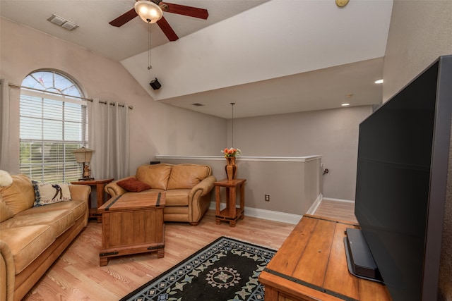 living room with ceiling fan, lofted ceiling, and light wood-type flooring