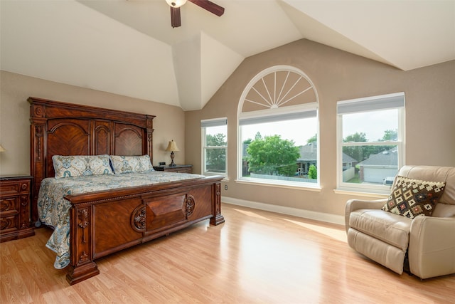 bedroom with light wood-type flooring, vaulted ceiling, and ceiling fan