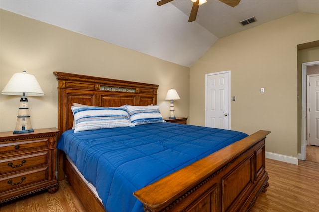 bedroom featuring ceiling fan, light wood-type flooring, and lofted ceiling