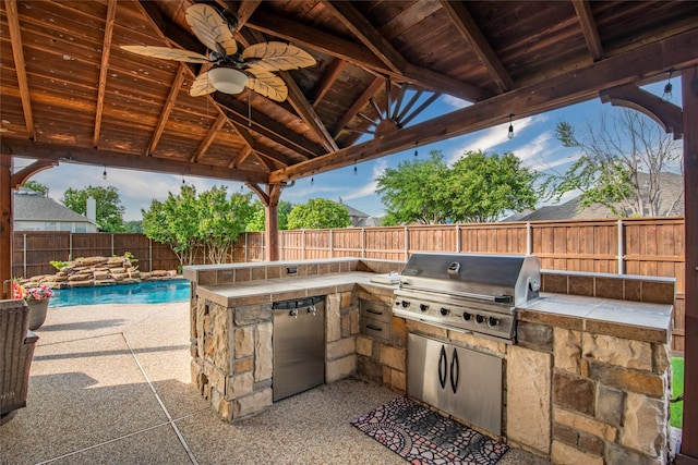 view of patio / terrace featuring area for grilling, a fenced in pool, a grill, a gazebo, and ceiling fan