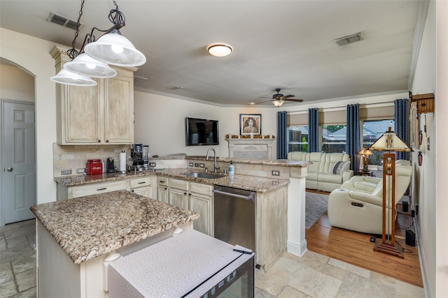 kitchen featuring ceiling fan, pendant lighting, sink, tasteful backsplash, and dishwasher