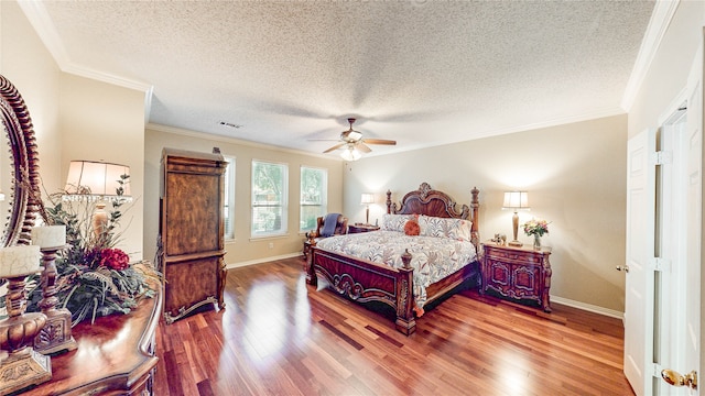 bedroom featuring ornamental molding, hardwood / wood-style flooring, a textured ceiling, and ceiling fan