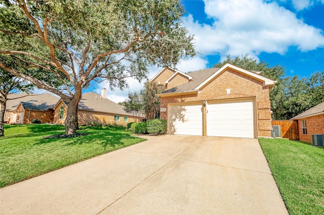 view of front of property featuring a front lawn, central AC, and a garage