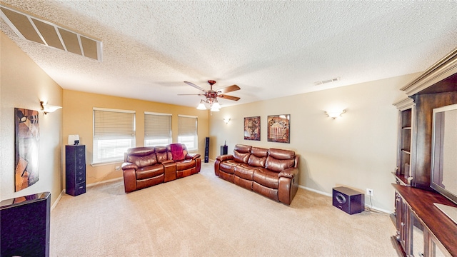 carpeted living room with ceiling fan and a textured ceiling