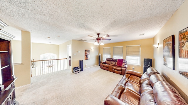 living room featuring ceiling fan, a textured ceiling, and carpet flooring