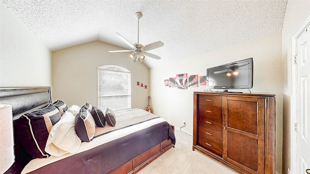 carpeted bedroom featuring ceiling fan, a textured ceiling, and vaulted ceiling