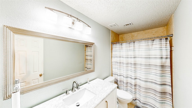 bathroom with a textured ceiling, walk in shower, vanity, and toilet