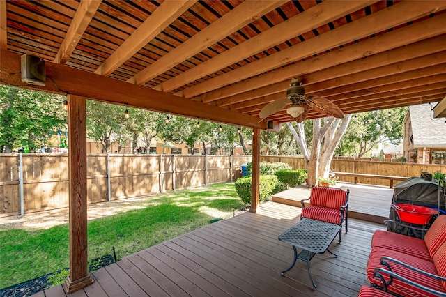 wooden deck with a yard and ceiling fan