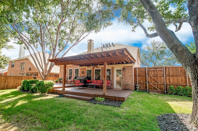 rear view of property featuring ceiling fan, an outdoor hangout area, a wooden deck, and a lawn