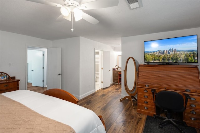 bedroom featuring a textured ceiling, connected bathroom, dark hardwood / wood-style floors, and ceiling fan