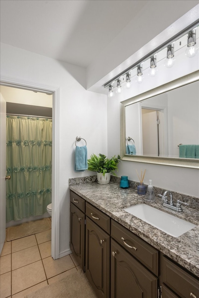 bathroom with tile patterned flooring, vanity, toilet, and a shower with curtain