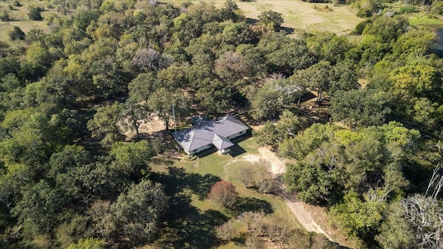 drone / aerial view featuring a wooded view