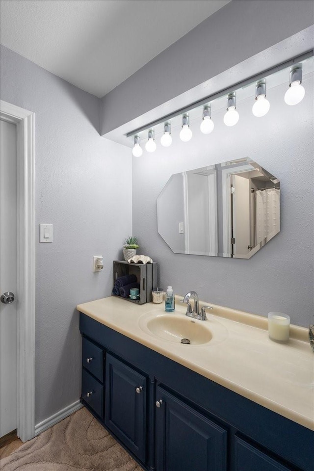 bathroom featuring vanity and baseboards