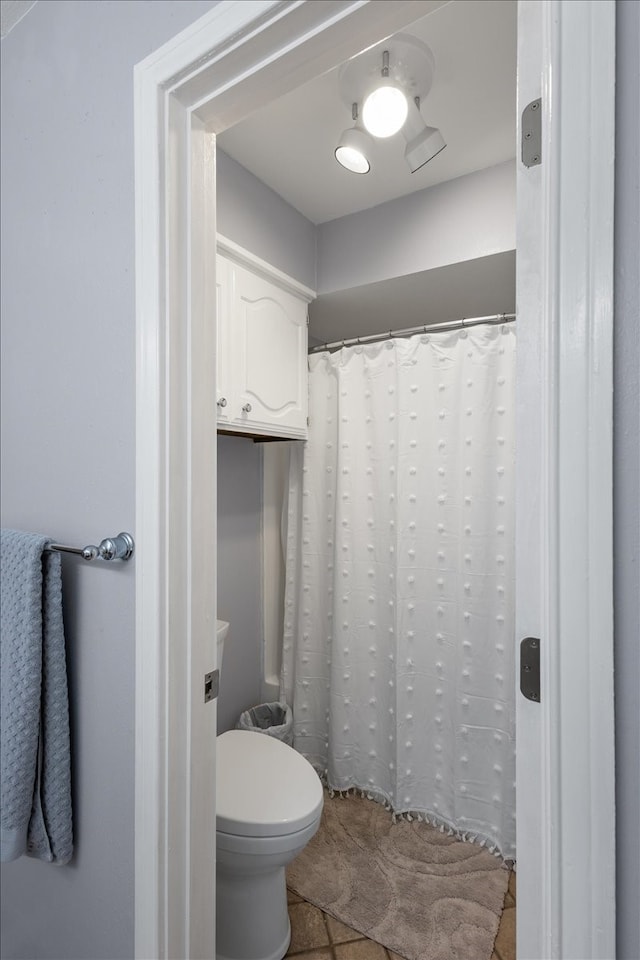 bathroom with tile patterned flooring and toilet