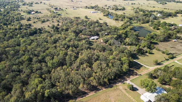 birds eye view of property with a water view and a rural view