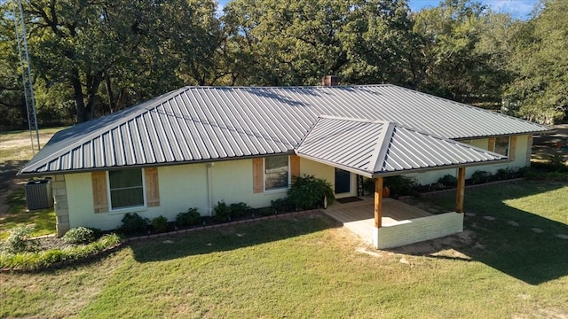 exterior space featuring a yard and metal roof