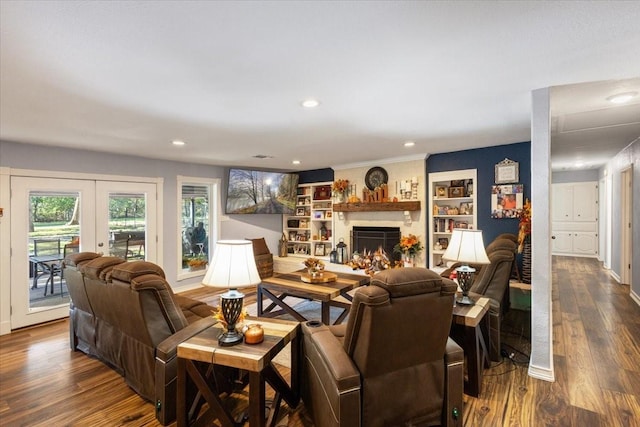 living area with french doors, recessed lighting, a fireplace, and dark wood finished floors