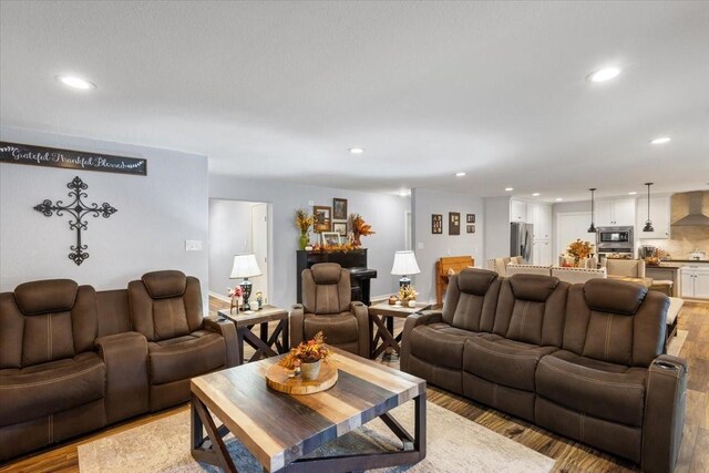 living room featuring light wood-style floors and recessed lighting