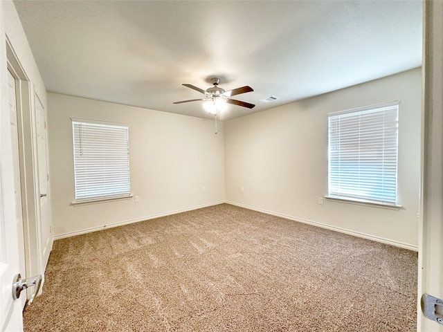 carpeted empty room featuring ceiling fan