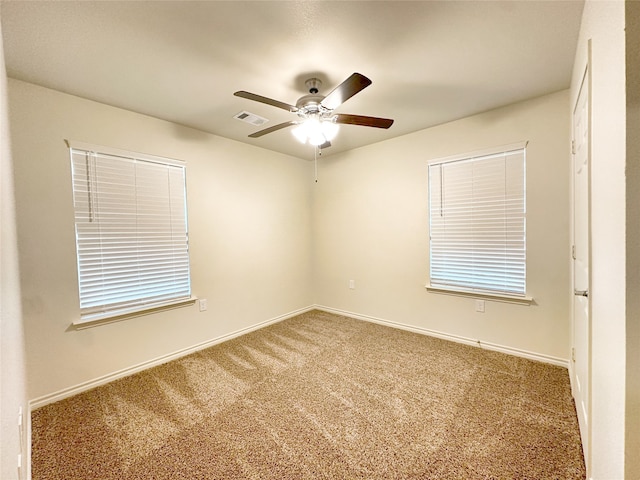 carpeted empty room featuring ceiling fan