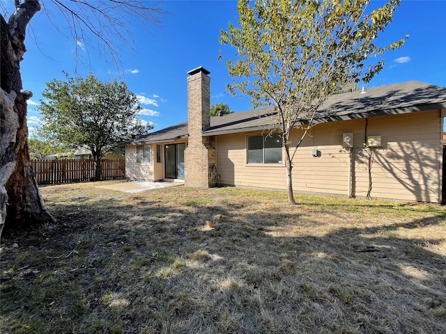 rear view of house with a yard