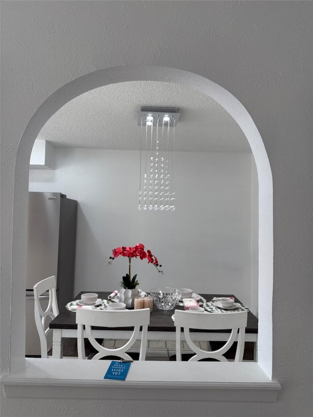 dining area with a textured ceiling