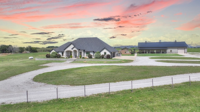 view of front of house featuring a garage and a yard