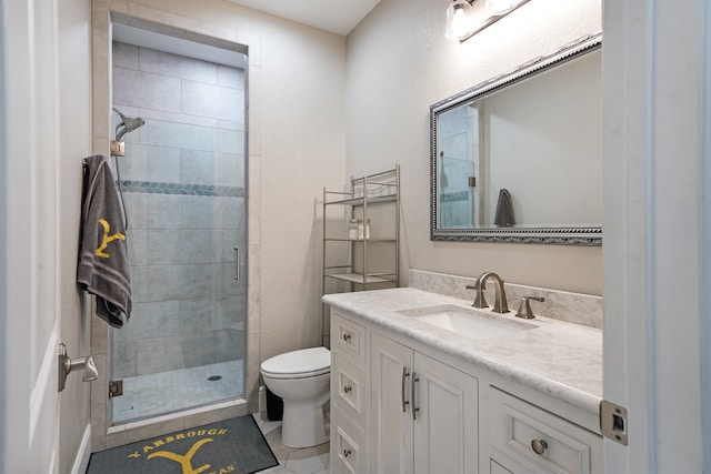 bathroom with vanity, a shower with shower door, toilet, and tile patterned flooring