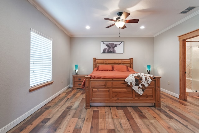 bedroom featuring ensuite bath, ceiling fan, hardwood / wood-style flooring, and crown molding