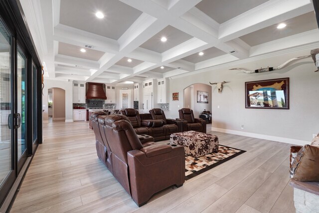 living room with light wood-type flooring, crown molding, coffered ceiling, and beamed ceiling