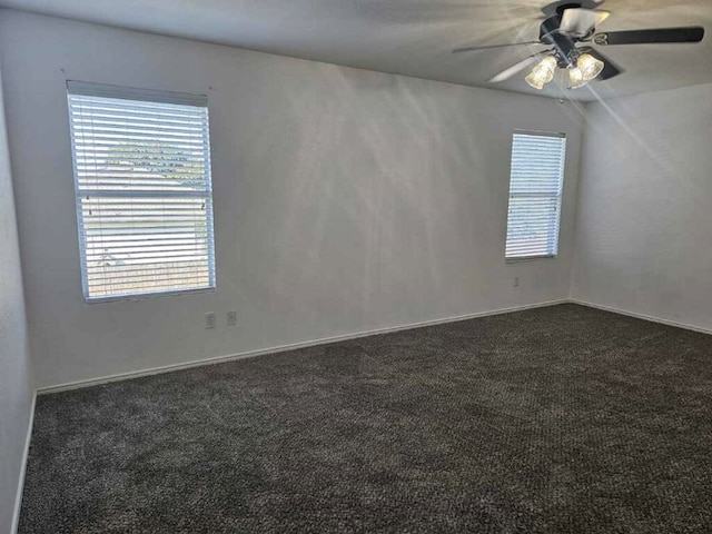 carpeted spare room featuring ceiling fan