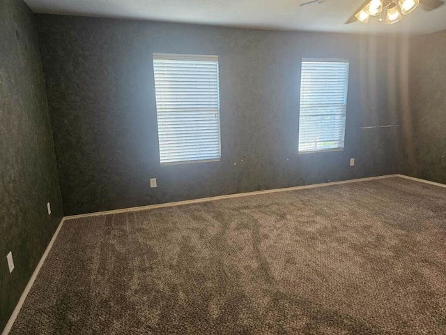 empty room with carpet flooring and ceiling fan