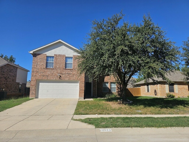 view of front of property featuring a garage and a front yard