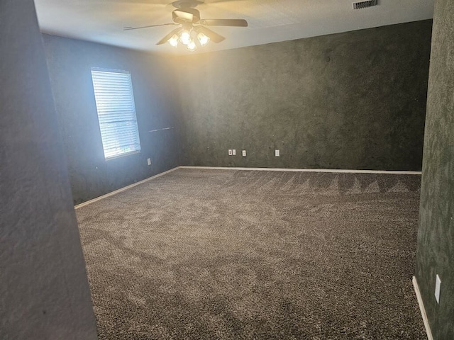 spare room with ceiling fan, carpet, and a textured ceiling