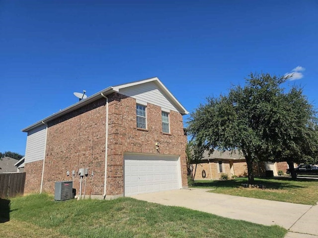 view of home's exterior featuring a yard, cooling unit, and a garage