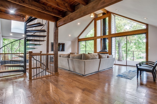 living room with beam ceiling, wood-type flooring, and high vaulted ceiling