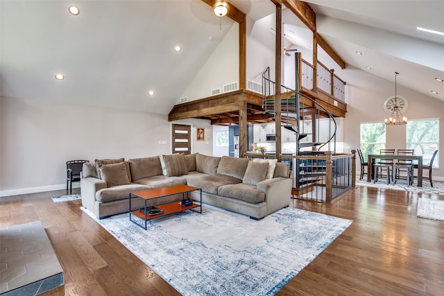 living room with a chandelier, dark hardwood / wood-style floors, and high vaulted ceiling