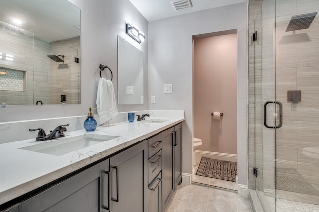 bathroom featuring vanity, toilet, tile patterned flooring, and an enclosed shower