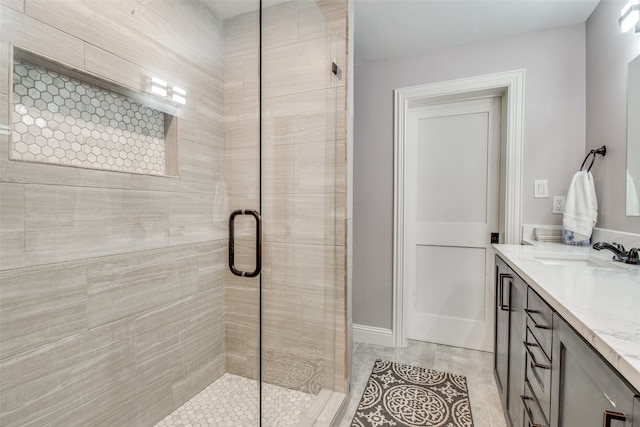 bathroom featuring vanity, tile patterned floors, and walk in shower