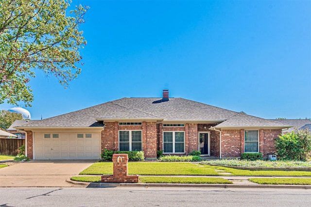 view of front of home featuring a garage and a front yard