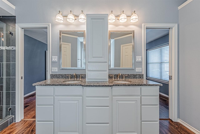 bathroom with vanity, an enclosed shower, and wood-type flooring