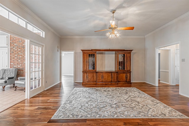 unfurnished living room featuring crown molding, ceiling fan, and dark hardwood / wood-style floors