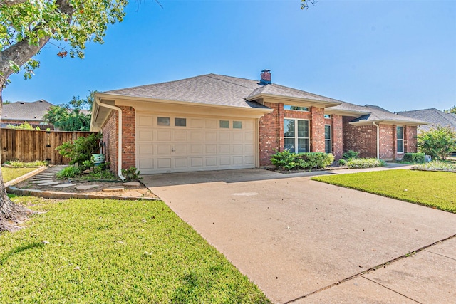 single story home featuring a garage and a front lawn