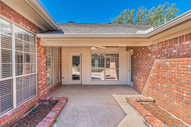 entrance to property with a patio area and ceiling fan