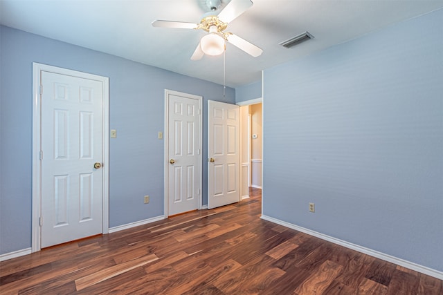 unfurnished bedroom with dark hardwood / wood-style flooring and ceiling fan