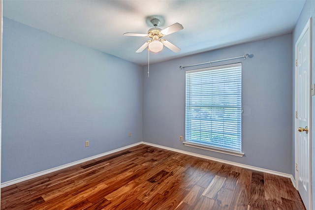 spare room featuring hardwood / wood-style flooring, ceiling fan, and a healthy amount of sunlight