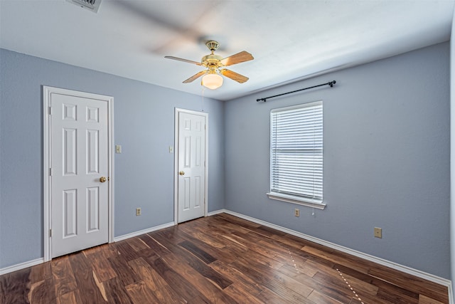 unfurnished room featuring dark hardwood / wood-style flooring and ceiling fan