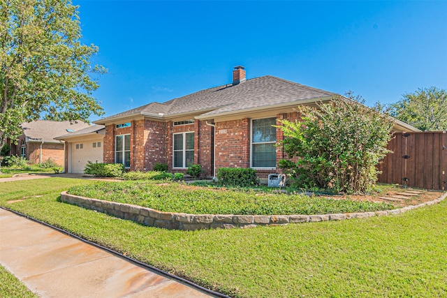 ranch-style home featuring a garage and a front lawn