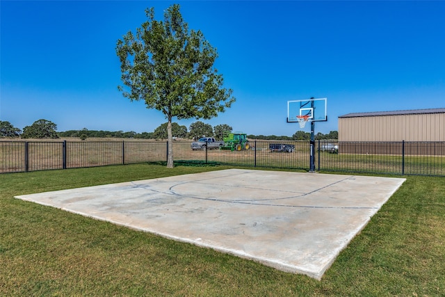 view of sport court featuring a lawn