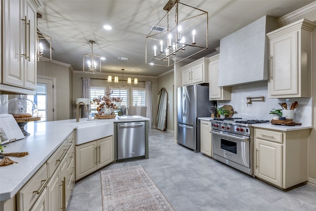 kitchen with light stone counters, ornamental molding, sink, decorative light fixtures, and stainless steel appliances